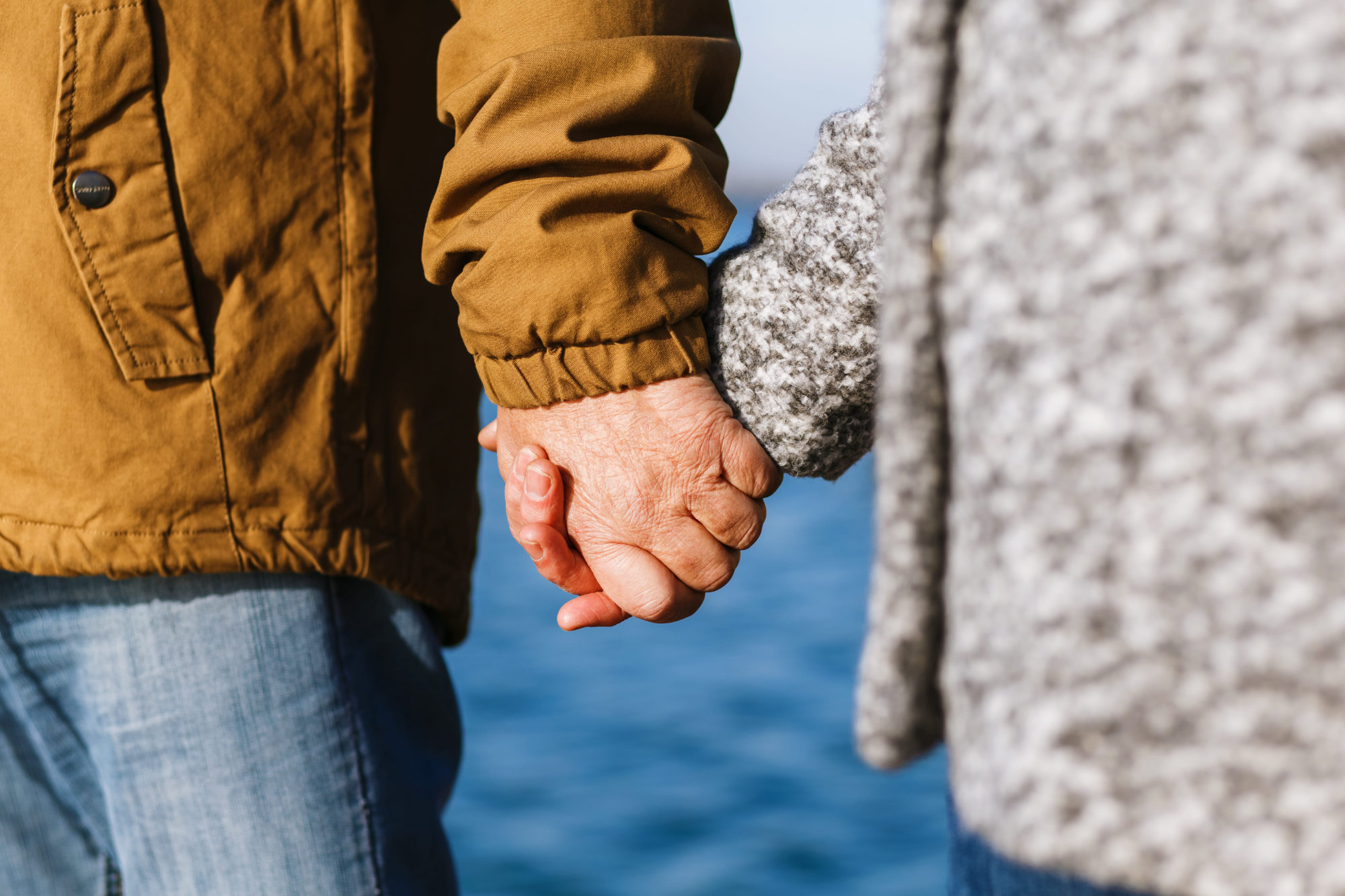 Couple holding hands, symbolizing partnership and support